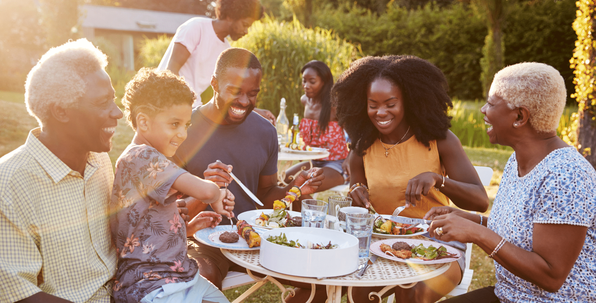 A family of multiple generations enjoying a meal together.
