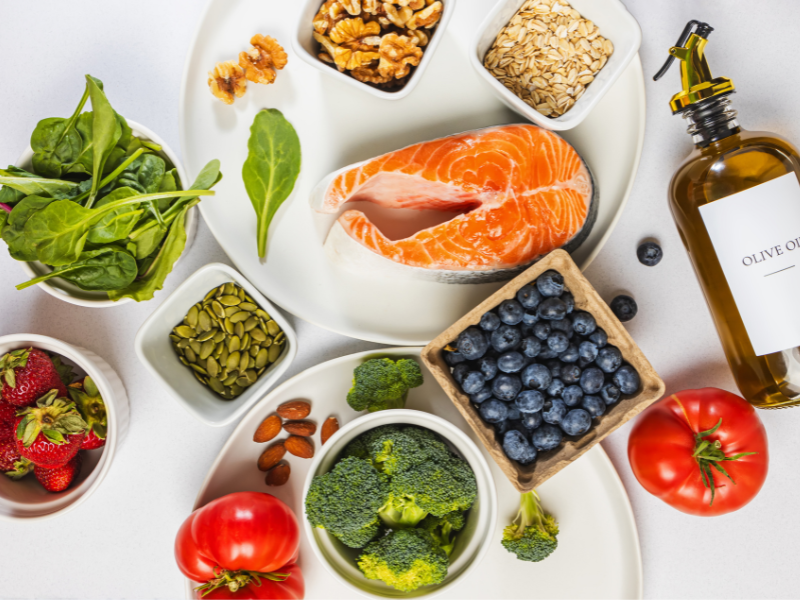 Healthy foods such as salmon, broccoli, and blueberries.