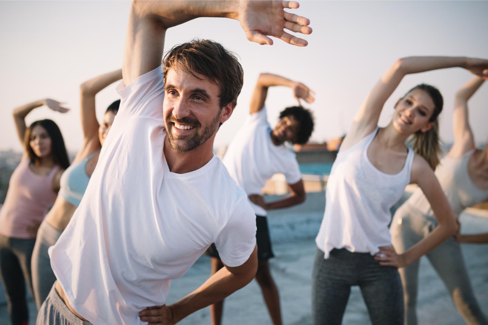 A group of people exercising outside.
